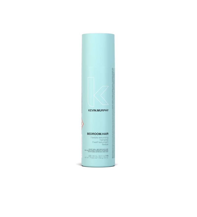 A can of **KEVIN.MURPHY BEDROOM.HAIR**, a lightweight, flexible hairspray designed to add touchable texture, movement, and volume. The sleek, matte bronze packaging reflects its effortless, tousled finish for perfectly undone, lived-in hair.