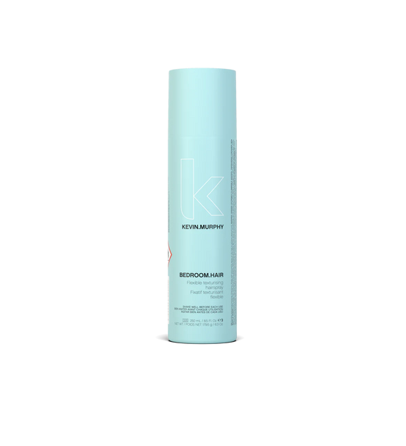 A can of **KEVIN.MURPHY BEDROOM.HAIR**, a lightweight, flexible hairspray designed to add touchable texture, movement, and volume. The sleek, matte bronze packaging reflects its effortless, tousled finish for perfectly undone, lived-in hair.