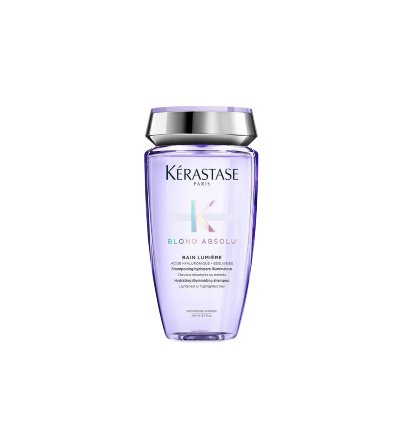 A bottle of **Kérastase Blond Absolu Bain Lumière Shampoo**, a hydrating and illuminating shampoo designed for blonde, lightened, or highlighted hair. Infused with hyaluronic acid and edelweiss flower, it gently cleanses while replenishing moisture, enhancing shine, and protecting hair from daily damage.