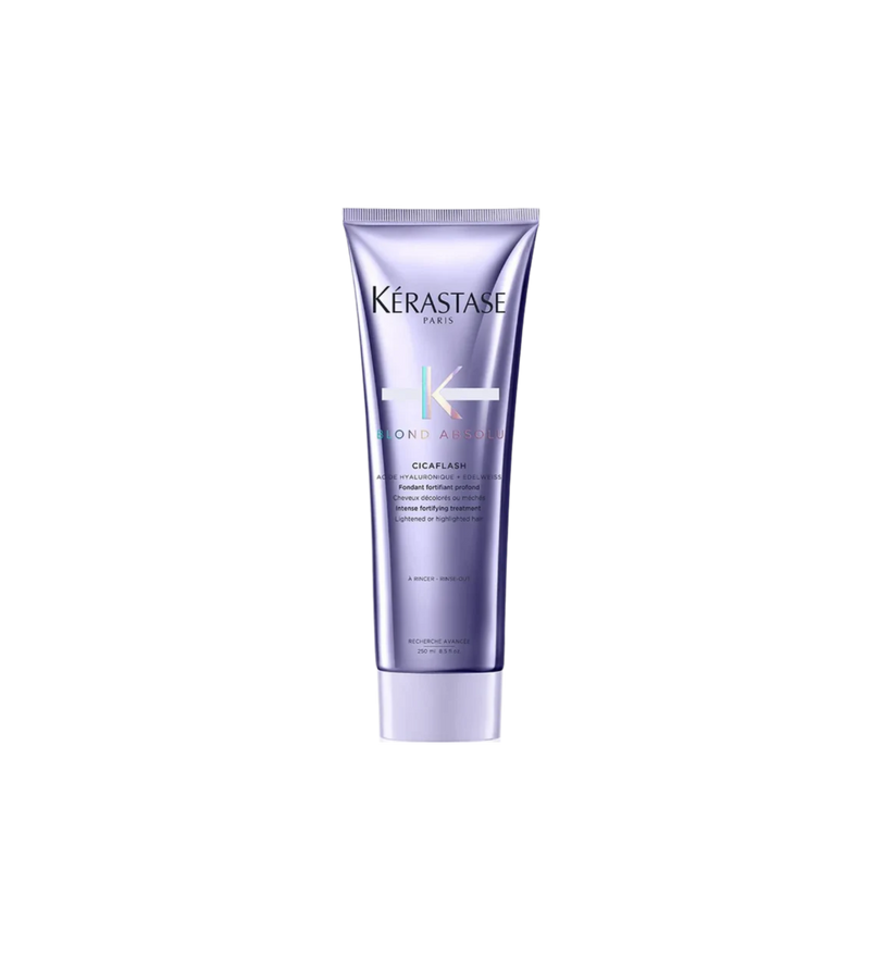 A bottle of **Kérastase Blond Absolu Cicaflash Conditioner**, a lightweight yet deeply nourishing conditioner designed for blonde, lightened, or highlighted hair. Combining the restorative power of a mask with the lightweight finish of a conditioner, it strengthens, hydrates, and protects against breakage while leaving hair soft, shiny, and luminous.