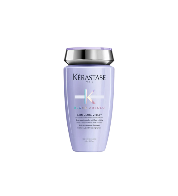 A bottle of **Kérastase Blond Absolu Bain Ultra-Violet**, a powerful purple shampoo formulated to neutralize yellow and brassy tones in blonde, lightened, or grey hair. Enriched with hyaluronic acid and edelweiss flower, it gently cleanses while strengthening and hydrating for a cooler, brighter blonde.