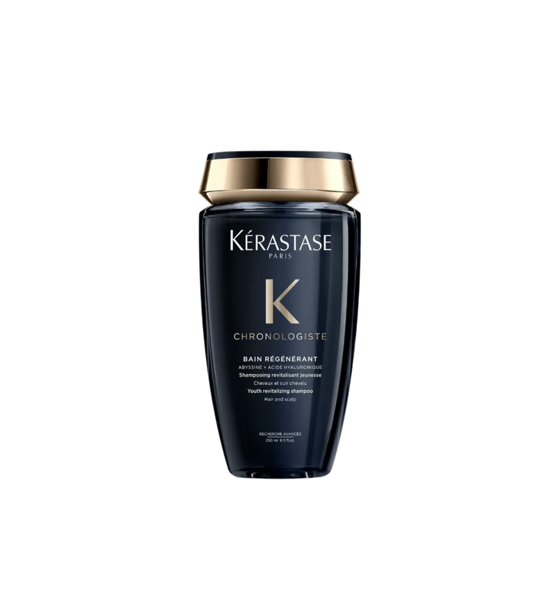 A bottle of **Kérastase Chronologiste Bain Régénérant**, a revitalizing shampoo that gently cleanses while restoring hydration, strength, and shine. Infused with hyaluronic acid, abyssine, and vitamin E, it combats signs of aging, smooths the hair fiber, and leaves hair feeling nourished and rejuvenated.