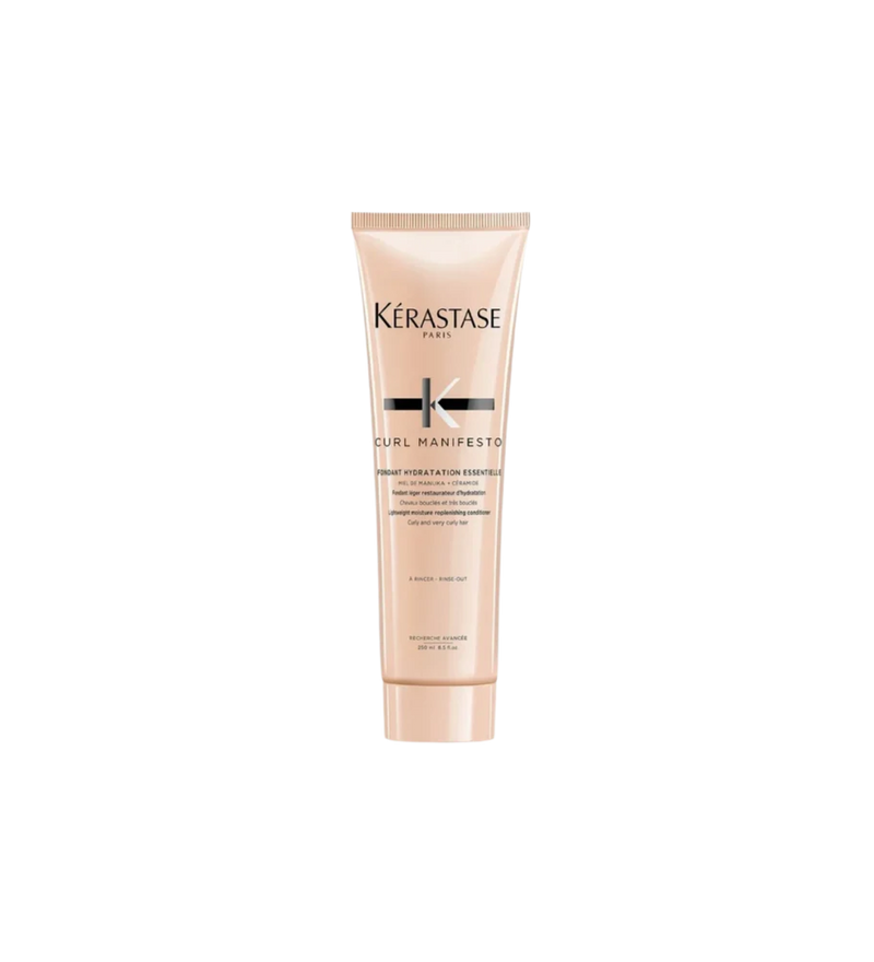 A bottle of **Kérastase Curl Manifesto Fondant Hydratation Essentielle**, a lightweight, hydrating conditioner designed to nourish and detangle curly, very curly, and coily hair. Infused with Manuka honey and ceramides, it enhances moisture retention, boosts curl definition, and leaves hair soft, smooth, and frizz-free.