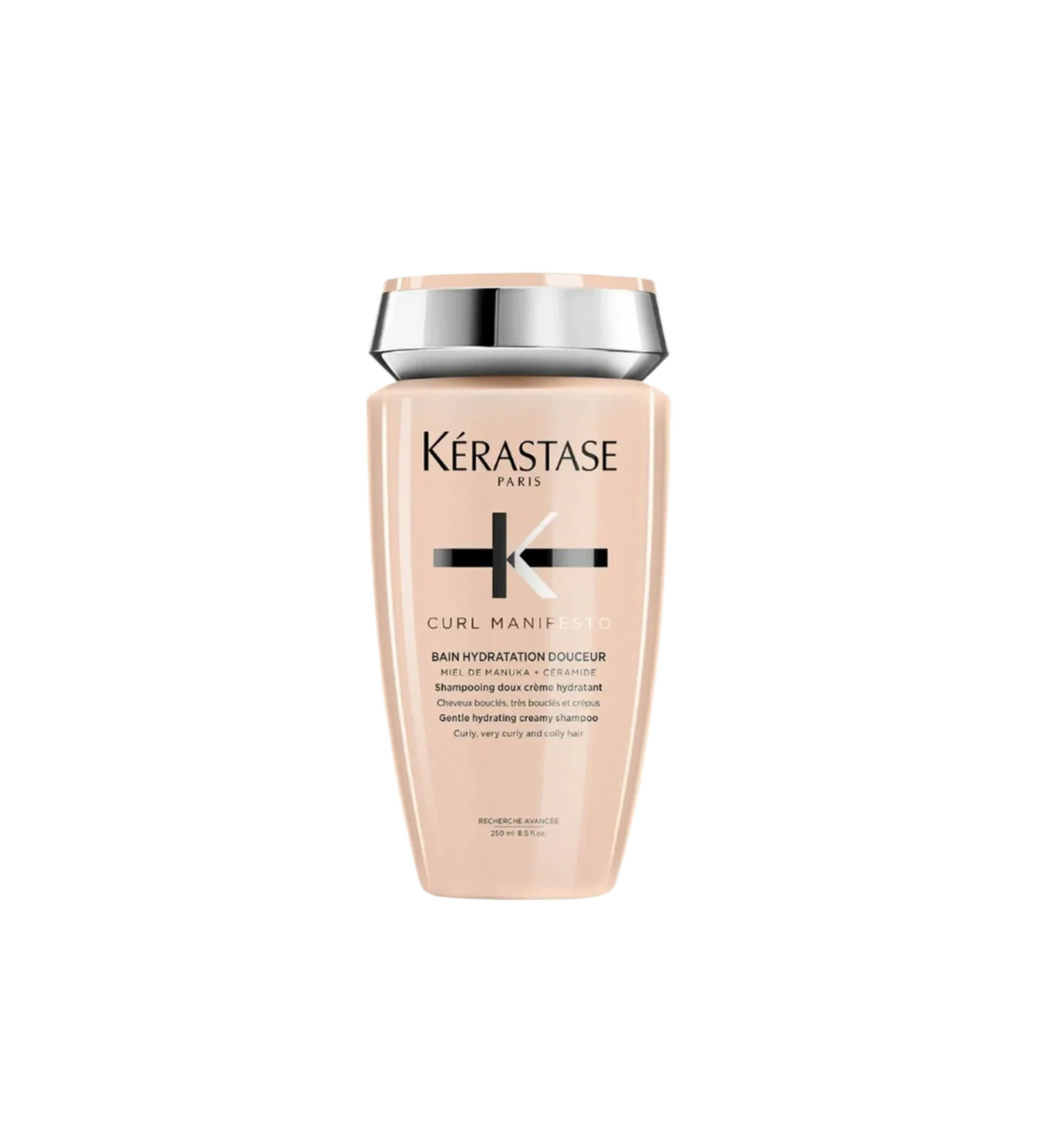A bottle of **Kérastase Curl Manifesto Bain Hydratation Douceur**, a gentle, hydrating shampoo designed to cleanse and nourish curly, very curly, and coily hair. Enriched with Manuka honey and ceramides, it removes impurities while maintaining essential moisture, enhancing curl definition, and reducing frizz for soft, healthy curls.