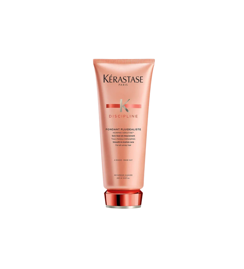 A bottle of **Kérastase Discipline Fondant Fluidealiste Smoothing Conditioner**, a lightweight, anti-frizz conditioner designed to smooth and soften unruly or frizzy hair. Infused with Morpho-Kératine™ technology, it enhances manageability, shine, and movement while providing humidity protection for a sleek, polished finish.