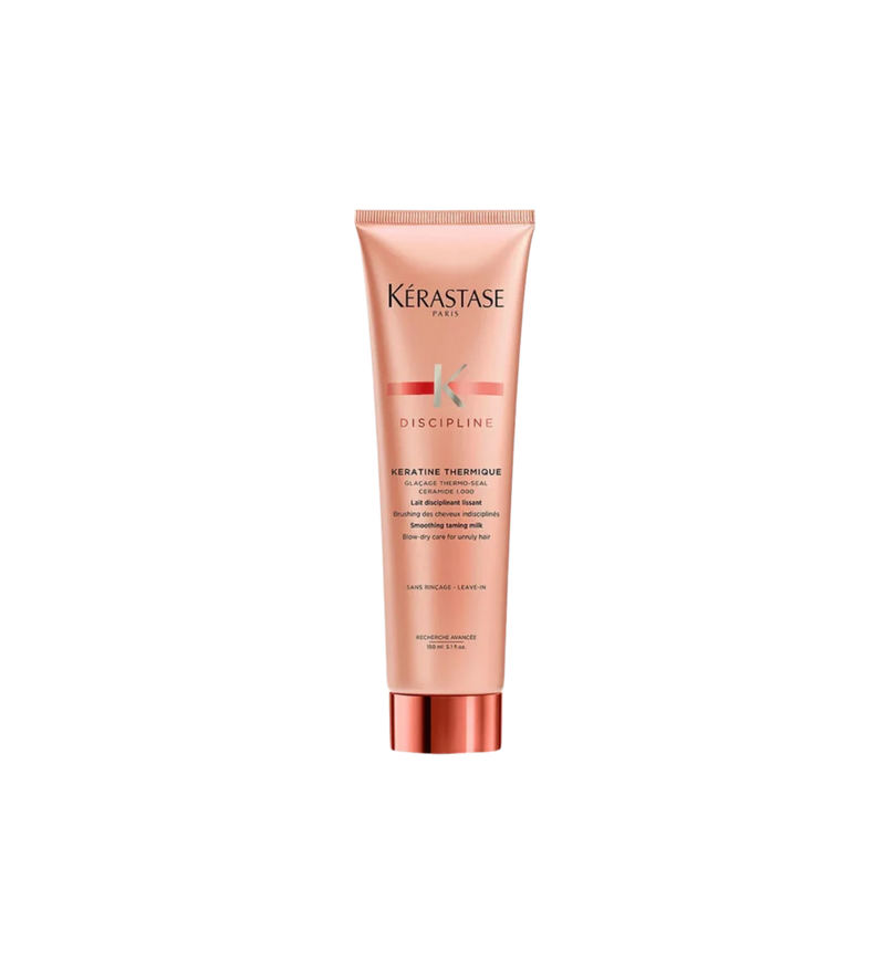 A bottle of **Kérastase Discipline Keratin Thermique Smoothing Heat Protectant Blow-Dry Primer**, a nourishing, anti-frizz cream that protects hair from heat damage while enhancing smoothness and manageability. Infused with Morpho-Kératine™ Complex, it tames frizz, reduces blow-dry time, and leaves hair soft, shiny, and effortlessly sleek.