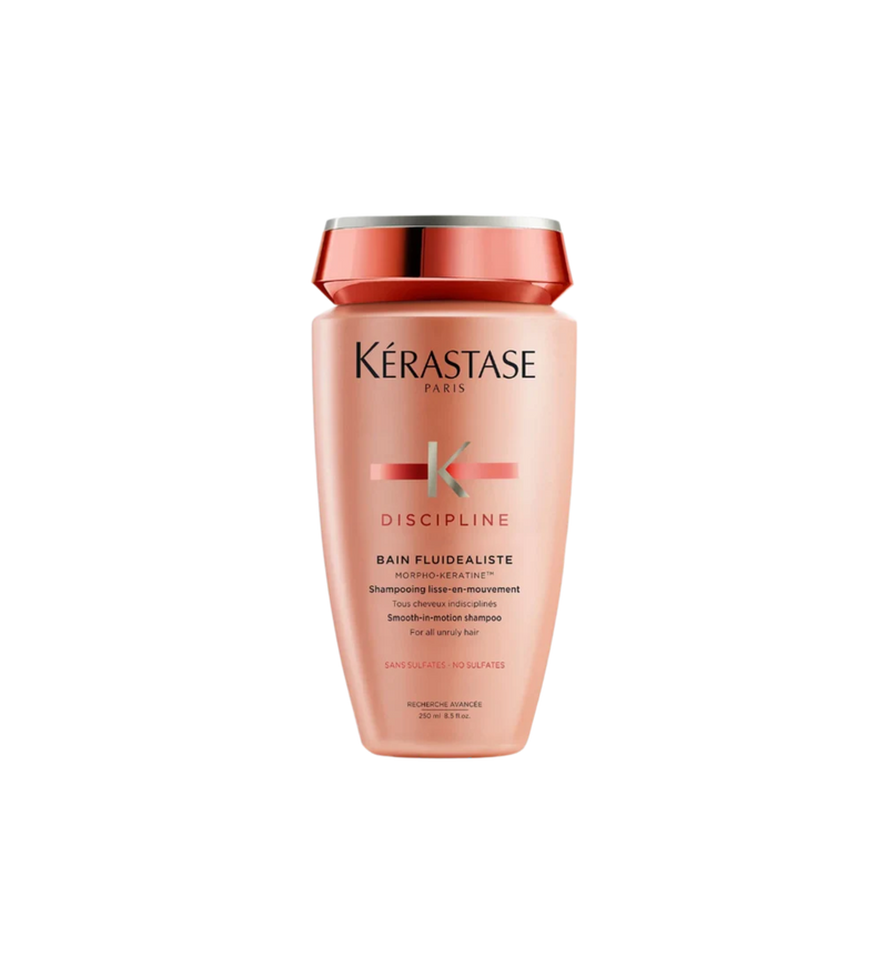 A bottle of **Kérastase Discipline Bain Fluidealiste Sulfate-Free Smoothing Shampoo**, a gentle, sulfate-free formula designed to cleanse, smooth, and control frizz while maintaining hair's natural movement. Enriched with Morpho-Kératine™ Complex, it provides humidity protection, enhances manageability, and leaves hair soft, shiny, and silky-smooth.