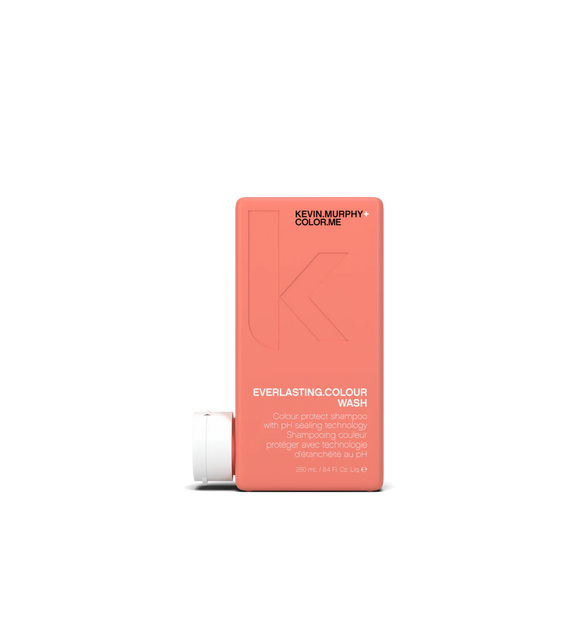 A bottle of **KEVIN.MURPHY EVERLASTING.COLOUR WASH**, a color-protecting shampoo designed to enhance vibrancy, strengthen hair, and lock in long-lasting shine. The sleek, matte pink packaging highlights its gentle, sulfate-free formula, perfect for maintaining color brilliance and hydration.