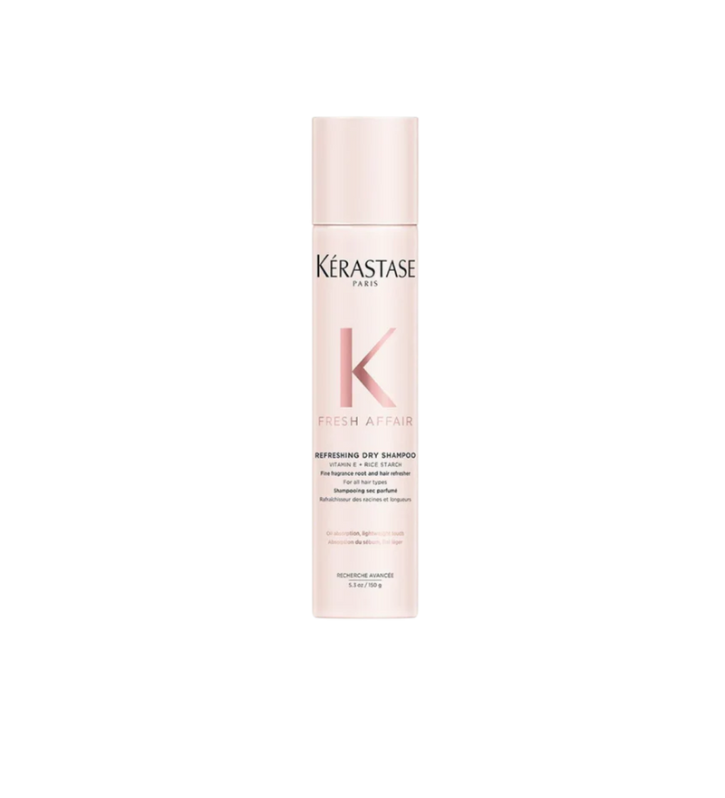 A bottle of **Kérastase FRESH AFFAIR Dry Shampoo**, a lightweight, fine-fragrance dry shampoo that instantly absorbs excess oil and refreshes hair between washes. The sleek, pastel pink packaging highlights its ultra-fine formula, infused with Vitamin E and a long-lasting neroli scent for a fresh, clean feel without residue.