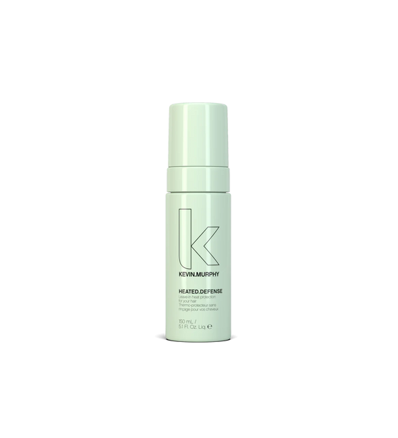 A bottle of **KEVIN.MURPHY HEATED.DEFENSE**, a weightless, leave-in heat protectant foam that shields hair from damage caused by styling tools up to 232°C (450°F). This strengthening formula helps reduce breakage while keeping hair smooth, hydrated, and protected.