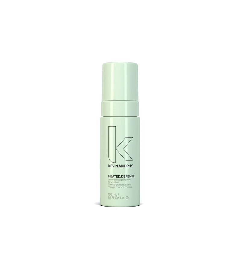 A bottle of **KEVIN.MURPHY HEATED.DEFENSE**, a weightless, leave-in heat protectant foam that shields hair from damage caused by styling tools up to 232°C (450°F). This strengthening formula helps reduce breakage while keeping hair smooth, hydrated, and protected.