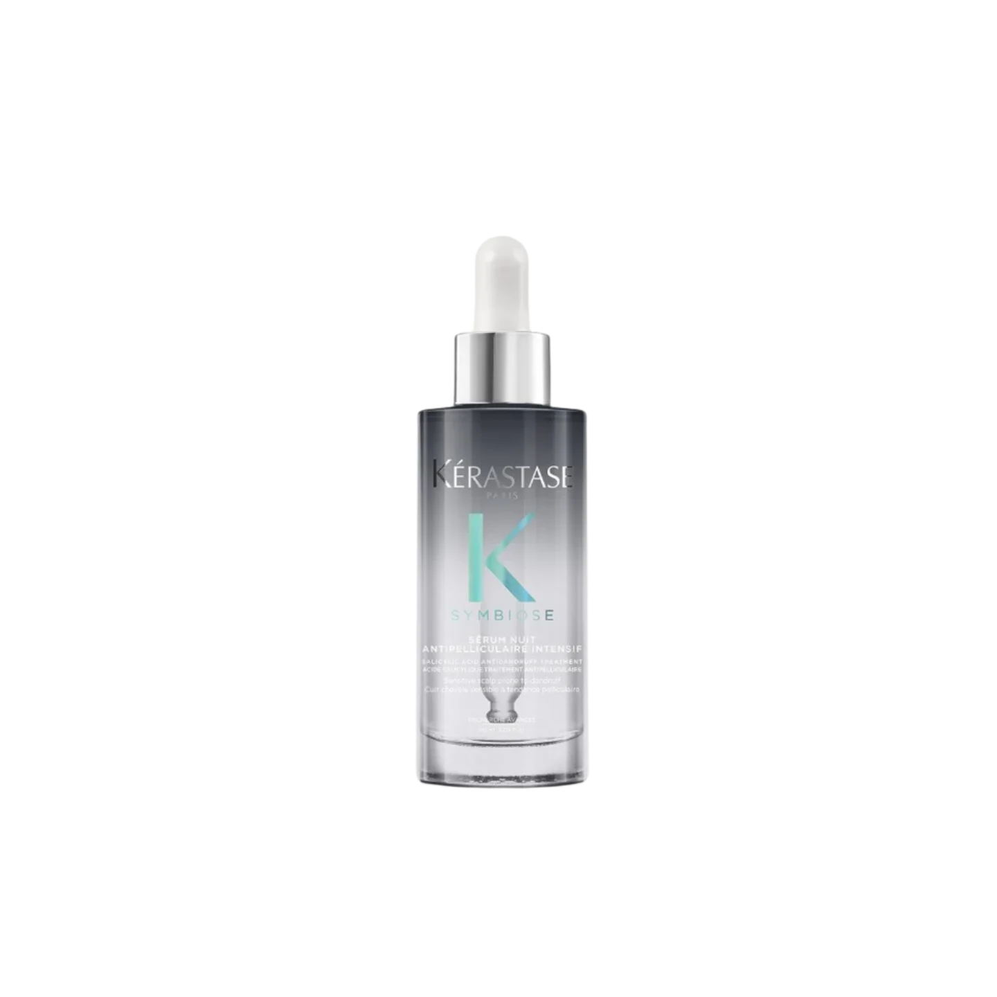 A bottle of **Kérastase Symbiose Cellulaire Nuit Anti-Dandruff Scalp Serum Intensif**, a luxurious overnight treatment designed to soothe the scalp and target dandruff at its source. Its lightweight formula works while you sleep to restore balance, providing long-lasting comfort and hydration.