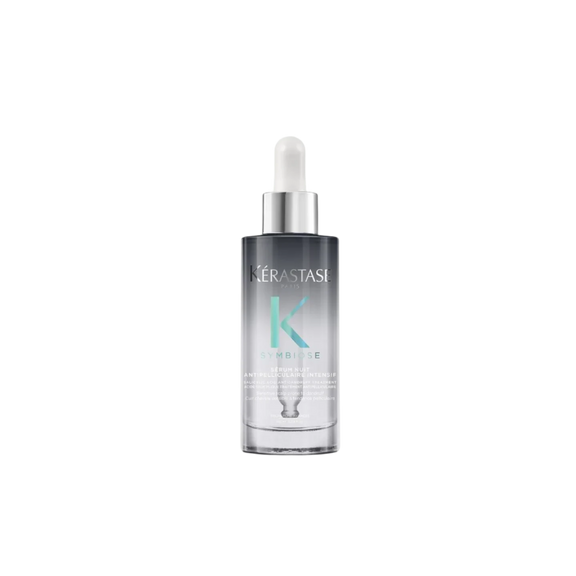 A bottle of **Kérastase Symbiose Cellulaire Nuit Anti-Dandruff Scalp Serum Intensif**, a luxurious overnight treatment designed to soothe the scalp and target dandruff at its source. Its lightweight formula works while you sleep to restore balance, providing long-lasting comfort and hydration.