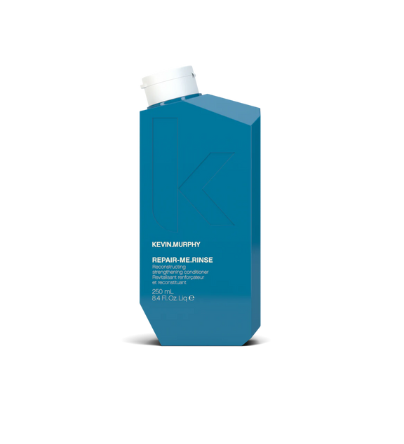 A bottle of **KEVIN.MURPHY REPAIR-ME.RINSE**, a strengthening and restorative conditioner formulated to nourish and repair damaged, brittle, or over-processed hair. Enriched with powerful proteins and amino acids, it helps rebuild and smooth hair while adding hydration, softness, and shine.