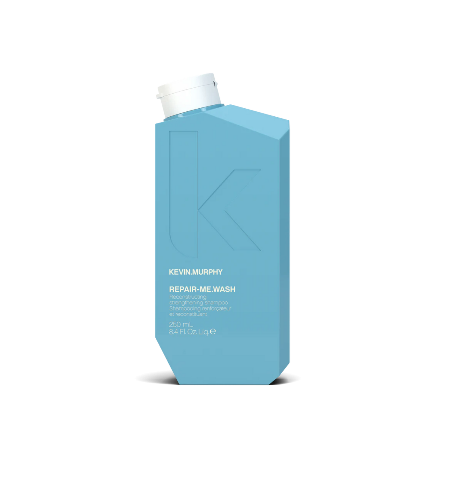 A bottle of **KEVIN.MURPHY REPAIR-ME.WASH**, a reconstructing shampoo designed to strengthen and restore damaged or over-processed hair. Infused with proteins and nourishing ingredients, it gently cleanses while helping to rebuild and fortify hair, leaving it soft, smooth, and healthy.