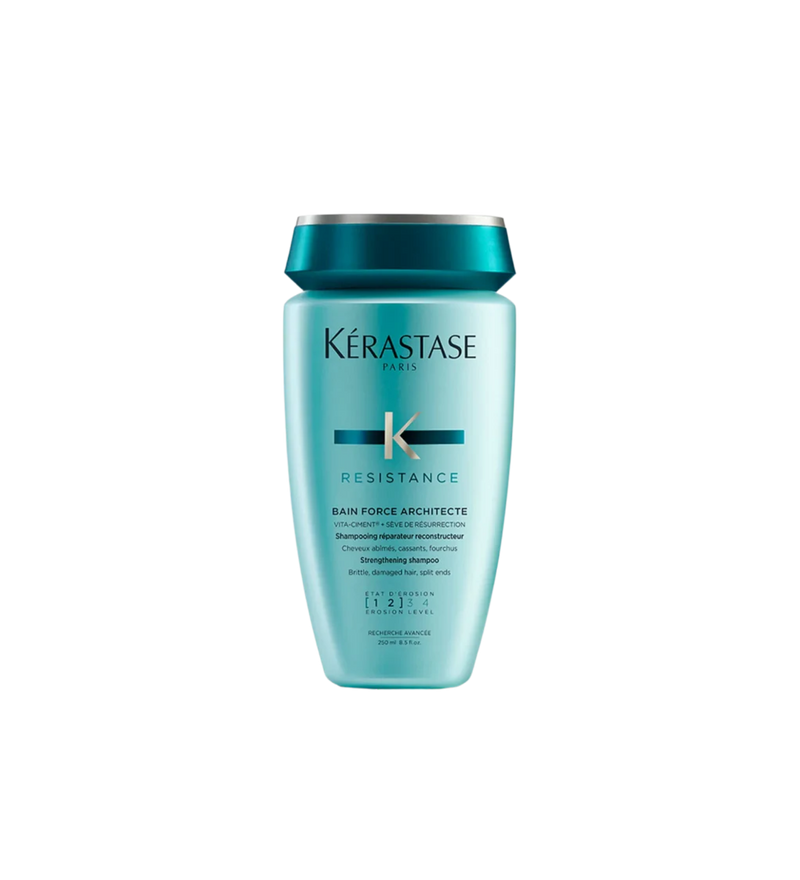  A bottle of **Kérastase Résistance Ciment Thermique**, a blow-dry primer designed to strengthen and protect damaged hair from heat styling. This lightweight, leave-in treatment helps prevent breakage while smoothing and fortifying hair for a sleek, healthy finish.
