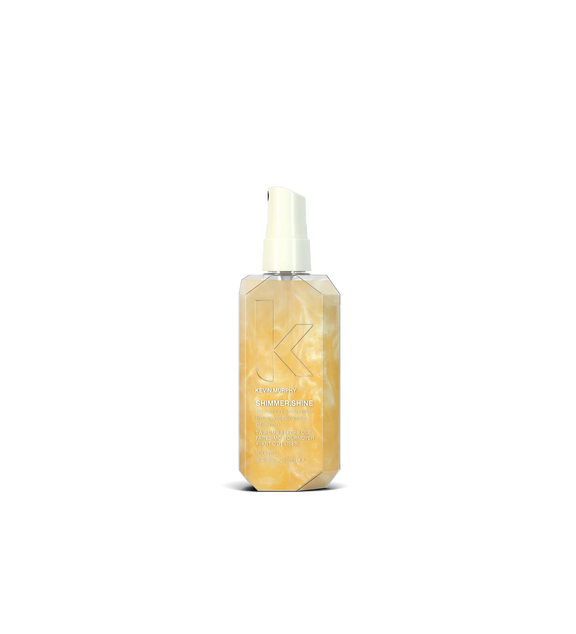 A bottle of **KEVIN.MURPHY SHIMMER.SHINE**, a lightweight finishing mist infused with light-reflecting technology to enhance shine and nourishment. Packed with essential oils, vitamins, and antioxidants, it revitalizes dull hair while adding a radiant, healthy glow without weighing it down.