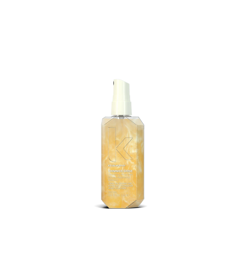 A bottle of **KEVIN.MURPHY SHIMMER.SHINE**, a lightweight finishing mist infused with light-reflecting technology to enhance shine and nourishment. Packed with essential oils, vitamins, and antioxidants, it revitalizes dull hair while adding a radiant, healthy glow without weighing it down.