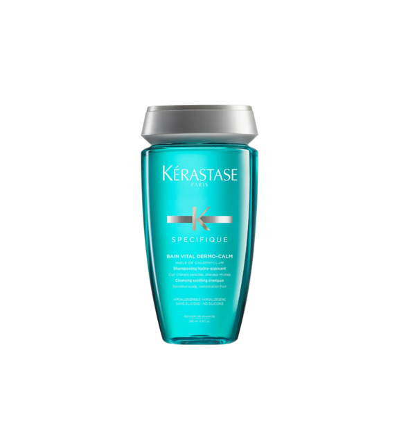 A bottle of **Kérastase Spécifique Bain Vital Dermo-Calm Shampoo**, a gentle, soothing formula designed for sensitive scalps. Infused with calming ingredients, it cleanses while reducing scalp discomfort, irritation, and dryness, leaving hair feeling fresh, light, and hydrated.