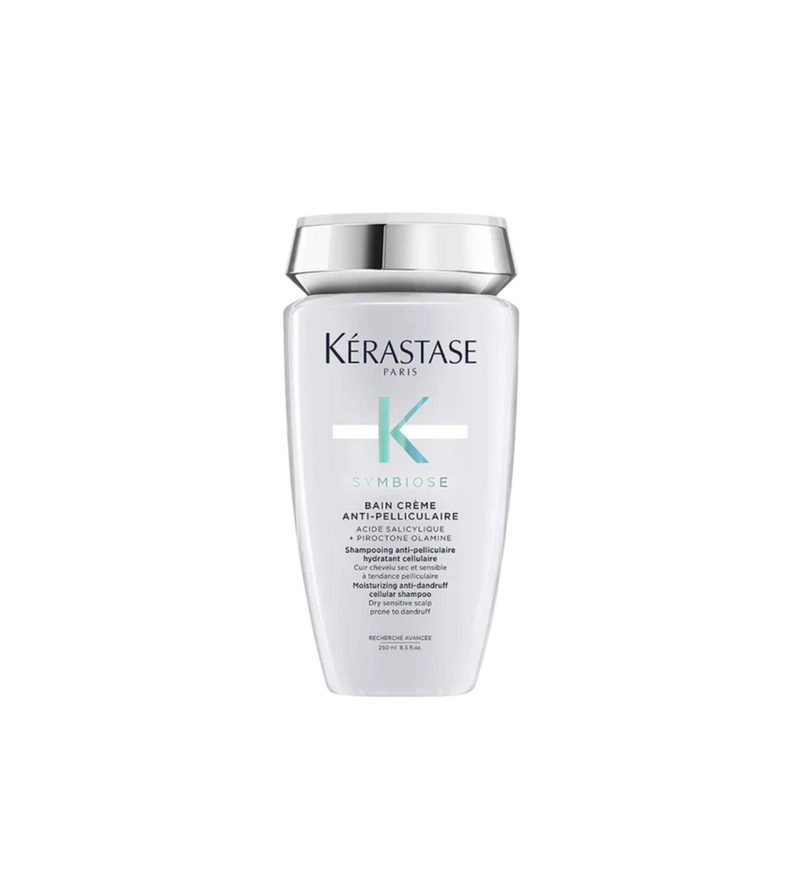 A bottle of **KERASTASE SYMBIOSE CRÈME HYDRATING ANTI-DANDRUFF SHAMPOO**, a luxurious, hydrating shampoo designed to gently remove dandruff while nourishing the scalp. Its rich, creamy formula soothes irritation, restores moisture, and leaves hair feeling soft, healthy, and flake-free. Perfect for dry, sensitive scalps in need of gentle yet effective care.
