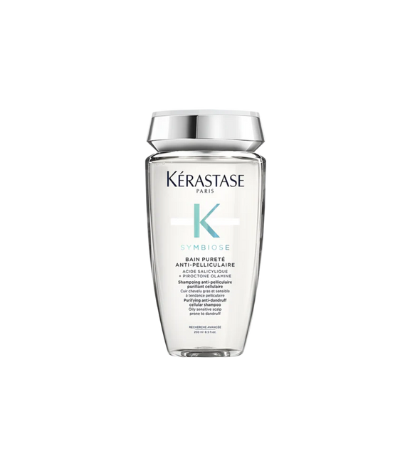 A bottle of **KERASTASE SYMBIOSE PURETÉ ANTI-DANDRUFF SHAMPOO FOR OILY SCALP**, a purifying shampoo designed to combat dandruff while balancing excess oil on the scalp. Its gentle formula cleanses deeply, removes flakes, and helps restore scalp health, leaving hair refreshed, light, and free from buildup. Perfect for those with oily scalps who want a fresh, clean feeling without dryness.