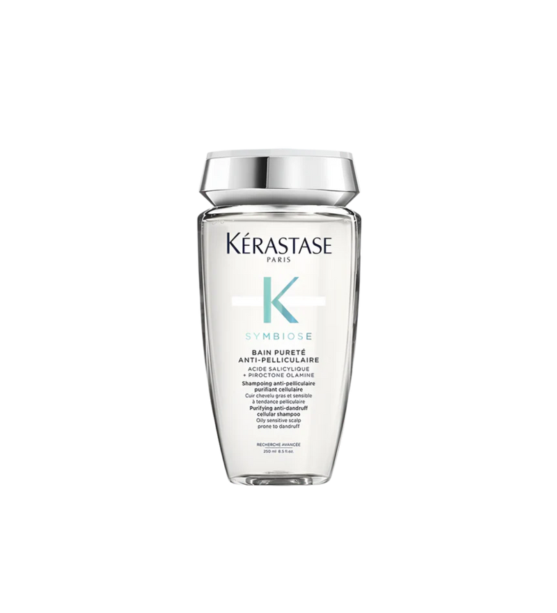 A bottle of **KERASTASE SYMBIOSE PURETÉ ANTI-DANDRUFF SHAMPOO FOR OILY SCALP**, a purifying shampoo designed to combat dandruff while balancing excess oil on the scalp. Its gentle formula cleanses deeply, removes flakes, and helps restore scalp health, leaving hair refreshed, light, and free from buildup. Perfect for those with oily scalps who want a fresh, clean feeling without dryness.