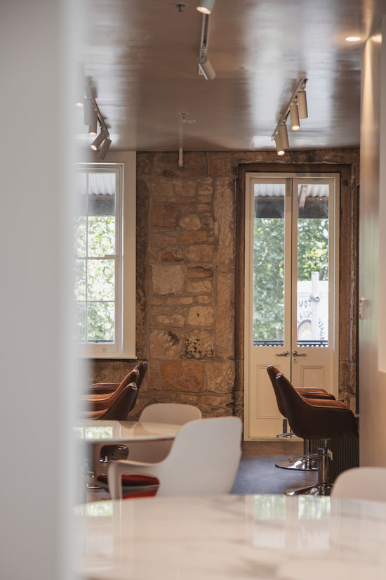 A view of **Neighbourhood Salon** on the **second floor** in **Darlinghurst, Sydney, near Surry Hills**, featuring a stylish, welcoming space with natural light, curated design elements, and a warm atmosphere for an elevated salon experience.